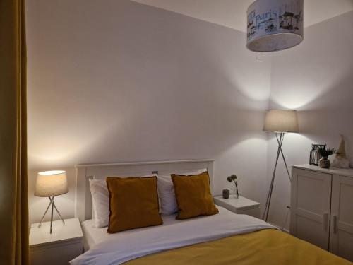 a bedroom with a bed with yellow pillows at MV Central Apartment & Garage - Self Check-in in Timişoara