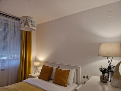 a bedroom with a white bed and a window at MV Central Apartment & Garage - Self Check-in in Timişoara