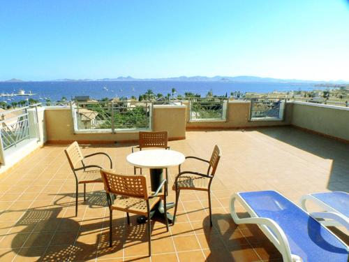 a patio with chairs and a table on a balcony at Hotel Monarque Costa Narejos in Los Alcázares