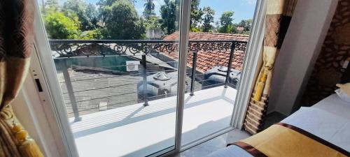 a view of a balcony from a room with a window at Ivory Laze Hotel in Negombo