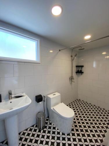 a bathroom with a toilet and a sink at Fides Boutique Hotel in Luang Prabang
