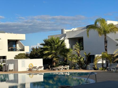 a hotel with a swimming pool in front of a building at Casa Ana - Luxury pool apartment at Casilla de Costa in Villaverde