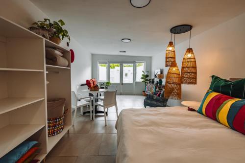 a room with a bed and a dining room at McLeod's & Stuart's Cottage in Somerset West