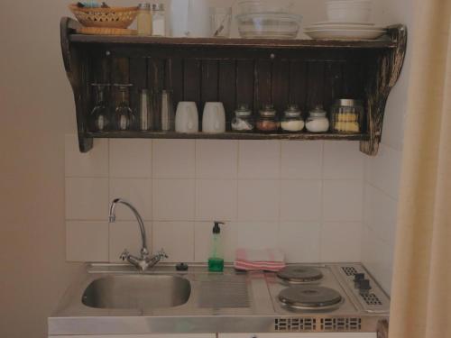 a kitchen counter with a sink and a stove at Grunau Chalets in Grünau