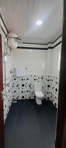 a bathroom with a toilet in a room at Ivory Laze Hotel in Negombo