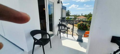 a balcony with chairs and a view of a balcony at Ivory Laze Hotel in Negombo