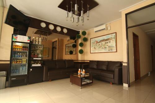 a living room with a couch and a table at Hotel Pules in Yogyakarta