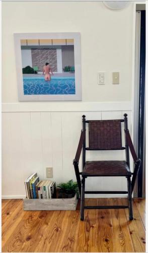 a chair sitting in a room with a swimming pool at ハルク キャビン in Nakijin