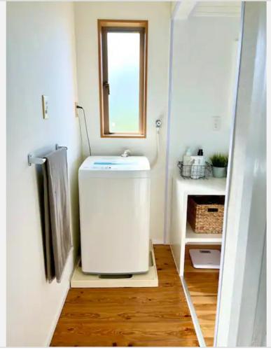 a small bathroom with a sink and a window at ハルク キャビン in Nakijin