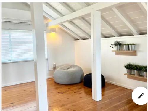 a room with a bean bag chair in a room with a ceiling at ハルク キャビン in Nakijin