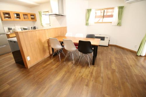 een keuken met een tafel en stoelen in een kamer bij Cottage All Resort Service / Vacation STAY 8402 in Inawashiro