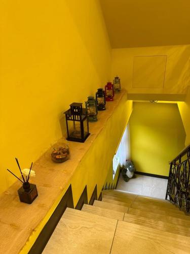 a yellow room with a staircase and a yellow wall at Bei Ao Bi Shan Jyu in Dongyin