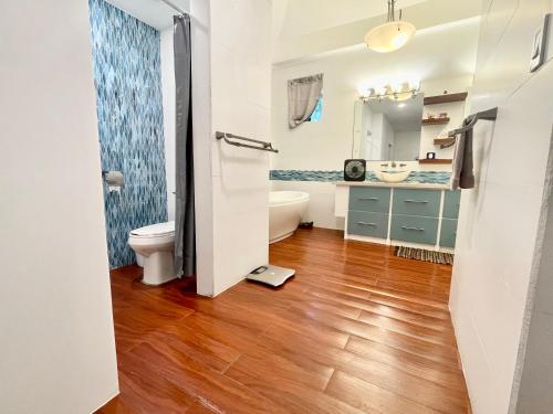 a bathroom with a toilet and a sink at Ngermid Oasis- 2 BD Master Suite in Koror