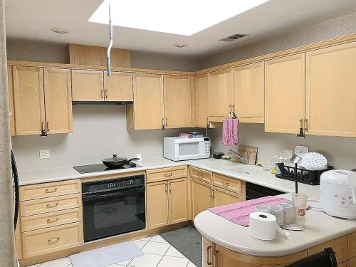 a kitchen with wooden cabinets and a stove top oven at New bedroom queen size bed at Las Vegas for rent-2 in Las Vegas