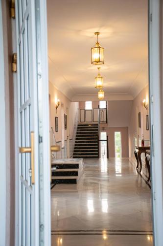 an open door to a hallway with stairs in a house at Naila Kothi - A Luxury Boutique Royal Suites in Jaipur in Jaipur
