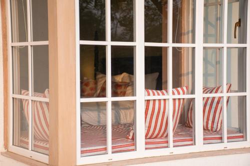 a casement window of a house with red and white stripes at Naila Kothi - A Luxury Boutique Royal Suites in Jaipur in Jaipur