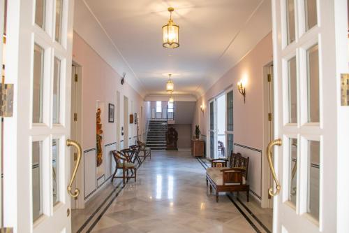 a hallway with chairs and tables in a building at Naila Kothi - A Luxury Boutique Royal Suites in Jaipur in Jaipur
