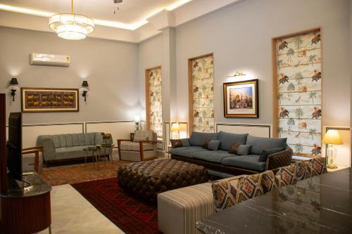 a living room with a couch and a tv at Naila Kothi, Jaipur in Jaipur