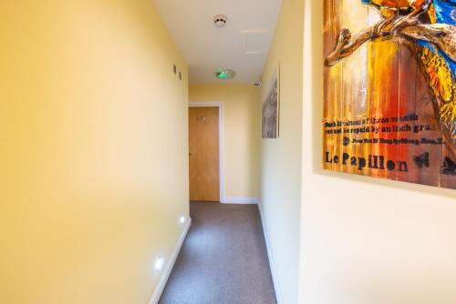 a hallway with a painting on the wall at The Shoreditch Inn in London