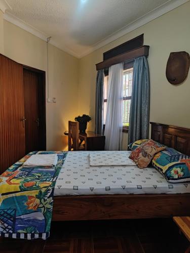 a bedroom with a bed and a window at Pentacasa in Jinja
