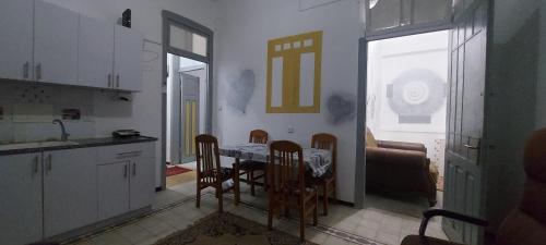 a kitchen and dining room with a table and chairs at Израиль Хайфа Адар in Haifa