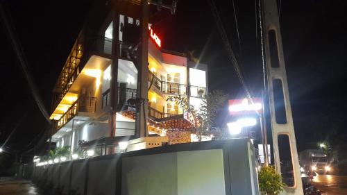 a building on a city street at night at Ivory Laze Hotel in Negombo