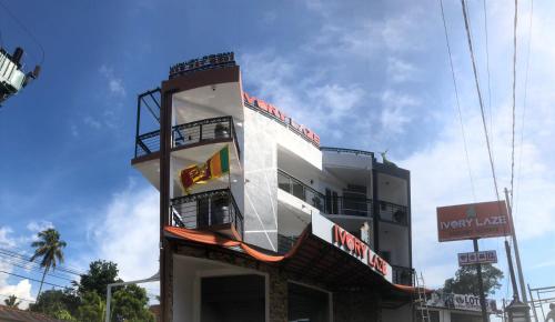a building with a sign on the side of it at Ivory Laze Hotel in Negombo
