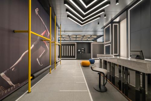 a hallway with a barber shop with yellow poles at Maqo Changsha in Changsha