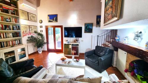 a living room with a couch and a fireplace at VILLA CECILIA sul LAGO fronte MARE in Sperlonga