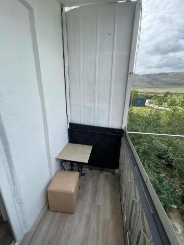 a small balcony with a bench and a window at My Sweet Home In Rustavi City 3 in Rustavi