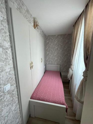a small bedroom with a bed with a pink mattress at My Sweet Home In Rustavi City 3 in Rustavi