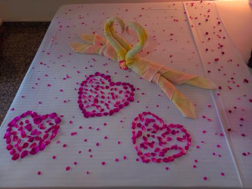 a cake with pink hearts on top of it at Ella Happy View Homestay in Ella