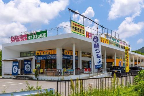 a large building with many signs on top of it at Cyclo Villa - JUNGLIA15分! 美ら海25分! ビーチ古宇利島すぐ! BBQ無料貸出! in Nago
