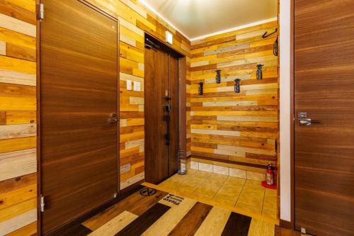 a bathroom with wooden walls and wooden doors at Cyclo Villa - JUNGLIA15分! 美ら海25分! ビーチ古宇利島すぐ! BBQ無料貸出! in Nago