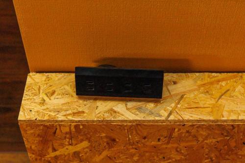 a black object sitting on top of a wooden box at Cyclo Villa - JUNGLIA15分! 美ら海25分! ビーチ古宇利島すぐ! BBQ無料貸出! in Nago