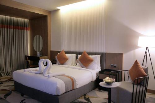 a hotel room with a bed with two swans on it at Al Muhaidb Residence Jawazat in Riyadh
