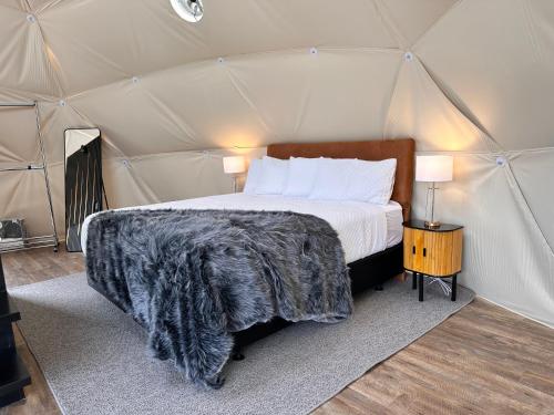 a bedroom with a bed in a tent at Glamping Dome - Pinot in Cromwell