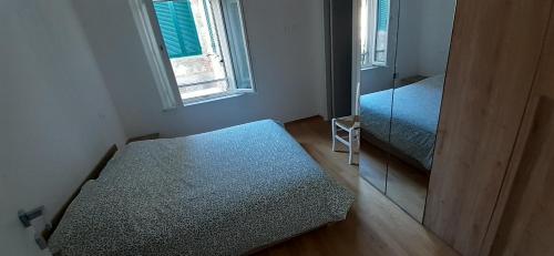 a small room with a bed and a window at La casa gialla del Ristoro Agricolo Vecchiano in Vecchiano
