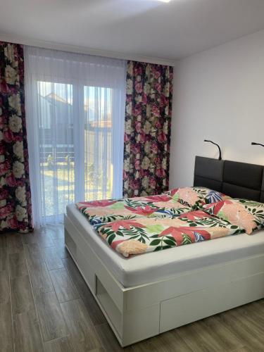 a bedroom with a bed and a window with curtains at 1 Tyskie Apartamenty z ogródkiem in Tychy