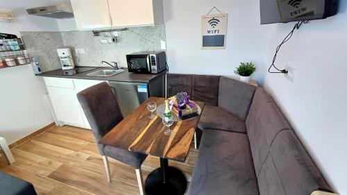 a living room with a couch and a wooden table at Apartmaji STARS in Mavčiče