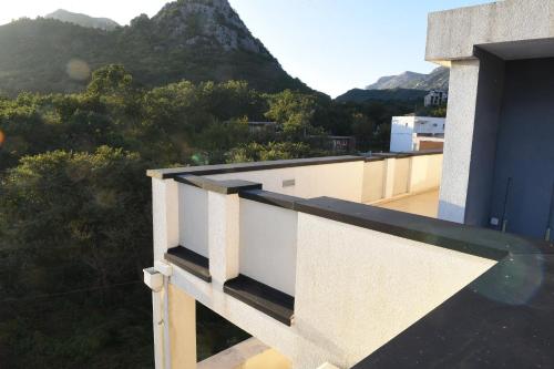 a balcony with a view of a mountain at Apartmani Sutomore Tri Palme in Sutomore