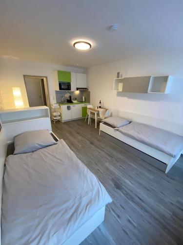 Habitación grande con 2 camas y cocina. en Apartment Kompakt 24/7, en Kassel