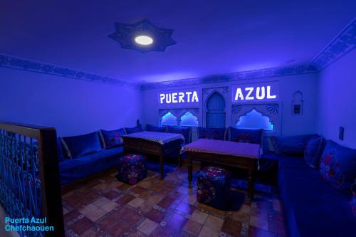 a living room with blue lighting and a couch at Puerta Azul in Chefchaouene
