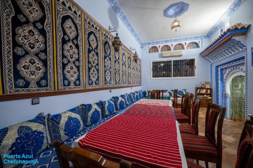 a dining room with a table and chairs at Puerta Azul in Chefchaouene