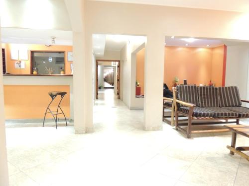 a lobby with chairs and a table in a building at Hotel Buenos Aires in Salta