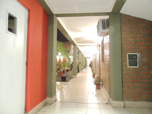 an empty hallway of a building with orange and green walls at Hotel Buenos Aires in Salta