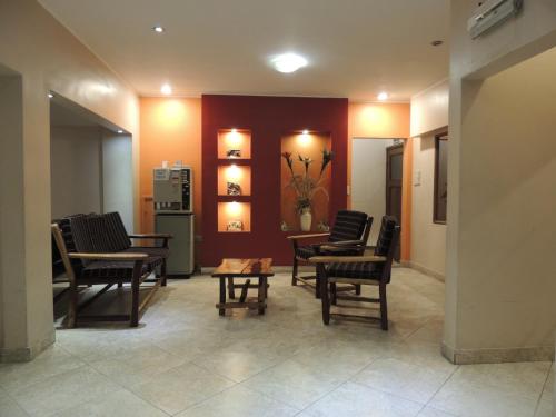 a waiting room with chairs and a refrigerator at Hotel Buenos Aires in Salta