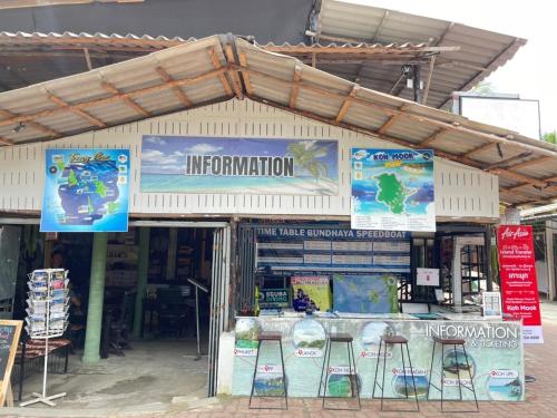 a store with chairs and signs in front of it at MOOK BOONCHU HOTEL in Koh Mook