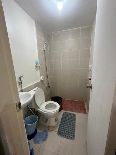 a small bathroom with a toilet and a sink at 3 Bedroom Apartment by Romz in Camaman