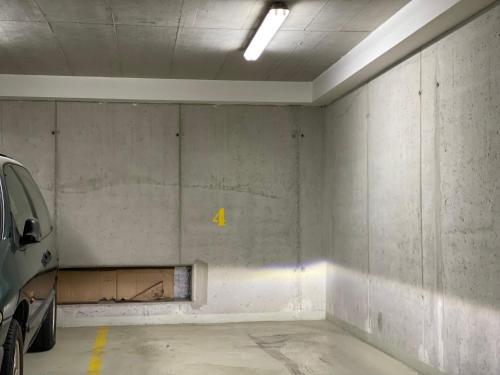 an empty parking garage with a car parked in it at Apartmán s garáží a balkónem in Pilsen